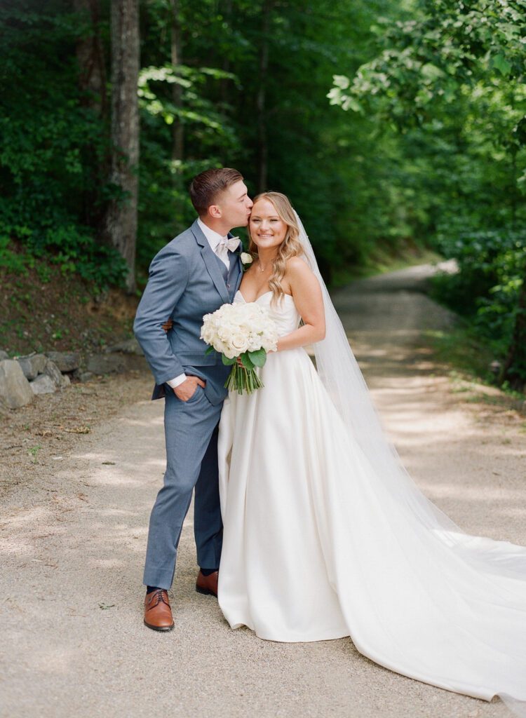 groom kissing bride on the head