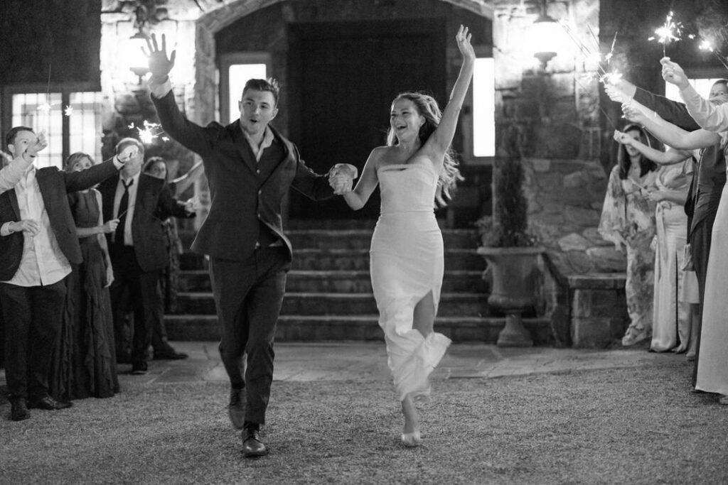 black and white of bride and groom sparkler exit