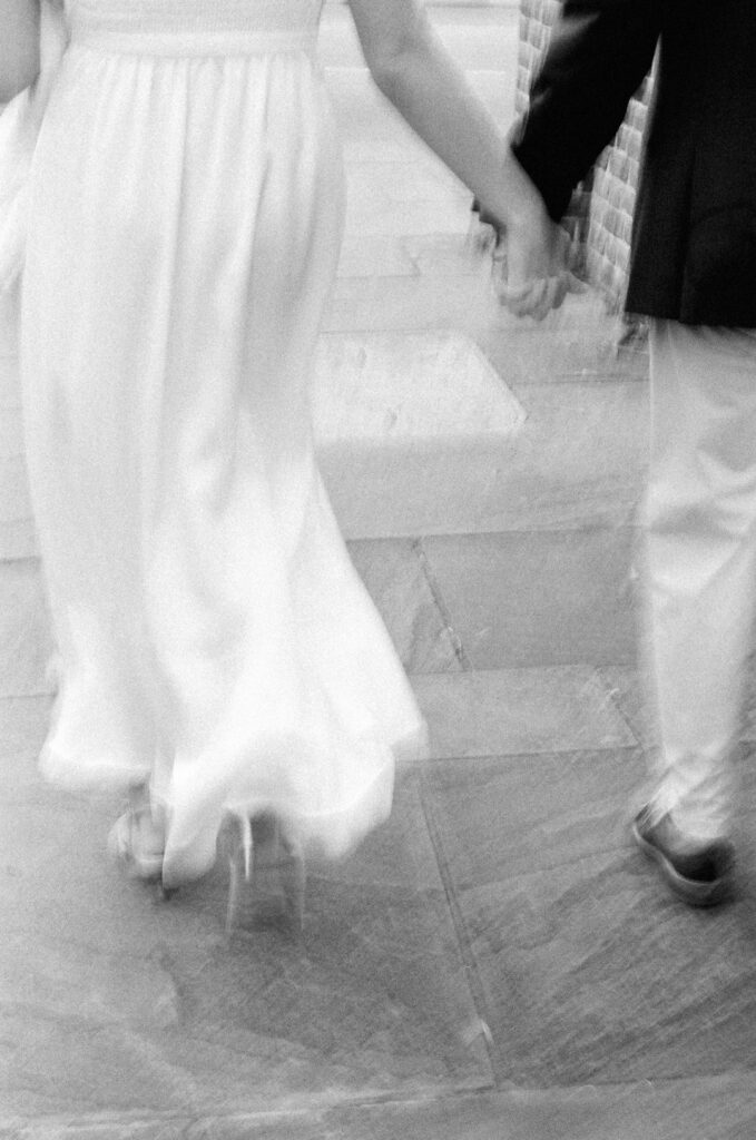 black and white motion blur of couple holding hands walking