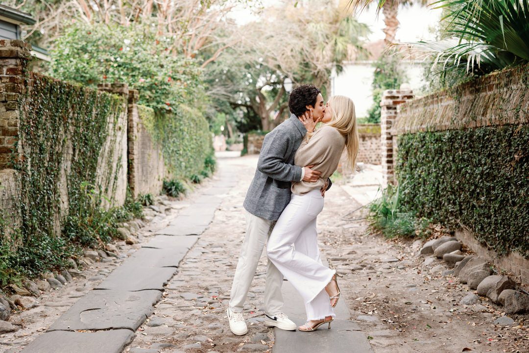 couple kissing in an alley for their Charleston Engagement Photos