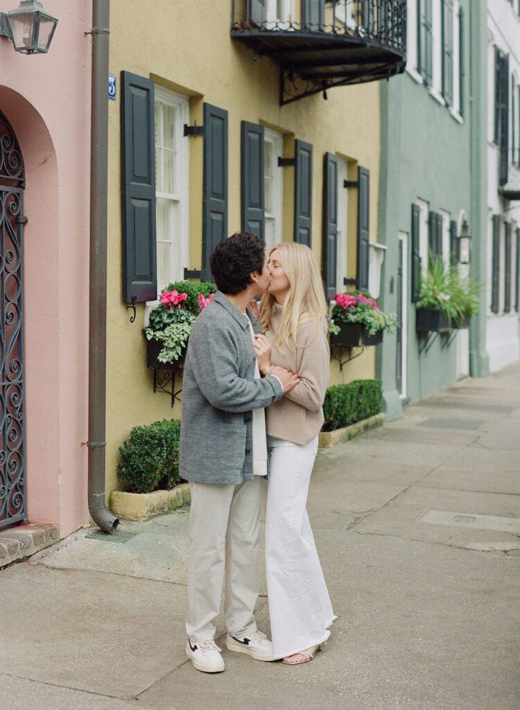 Couple kissing on rainbow row for their Charleston Engagement Photos