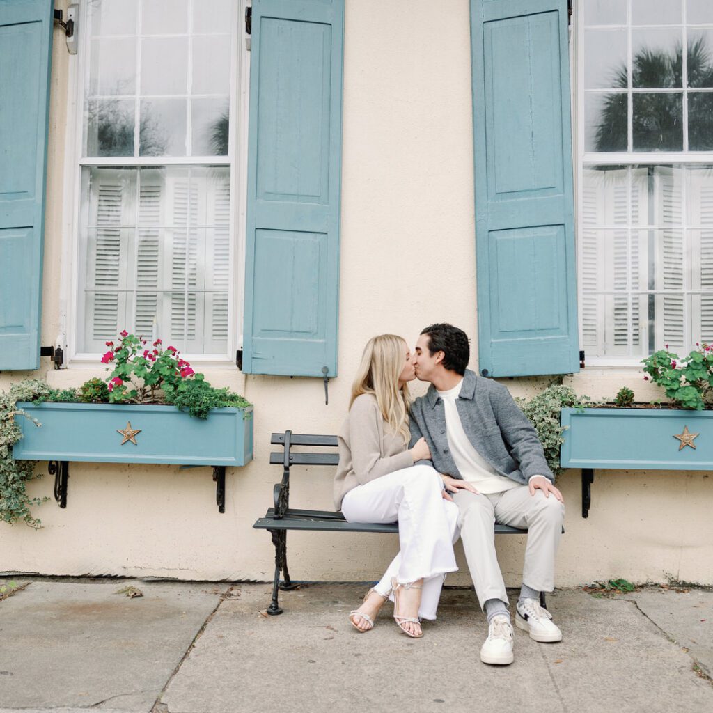 Couple sitting on bench kissing