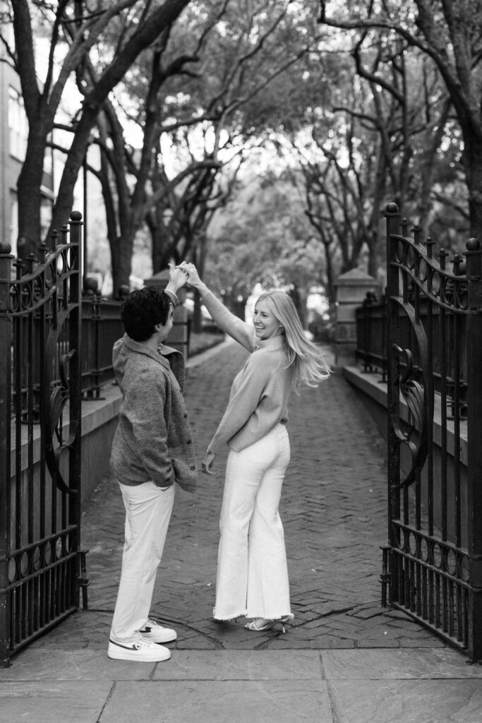 Black and White of couple spinning in gate