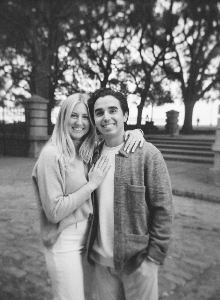 black and white of couple smiling at camera