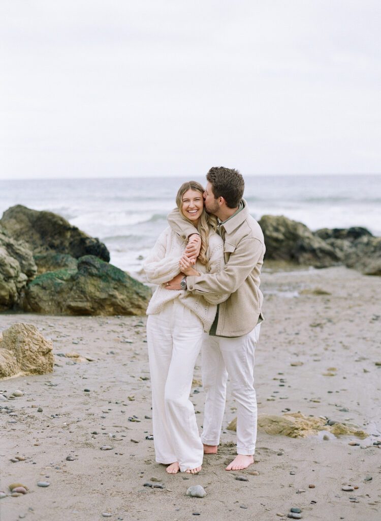 couple kissing and laughing