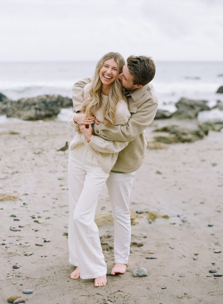 couple kissing and laughing