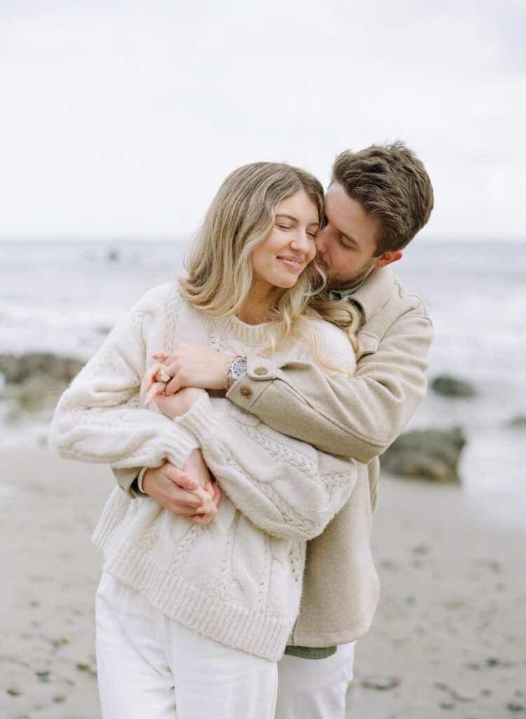 couple hugging on the beach