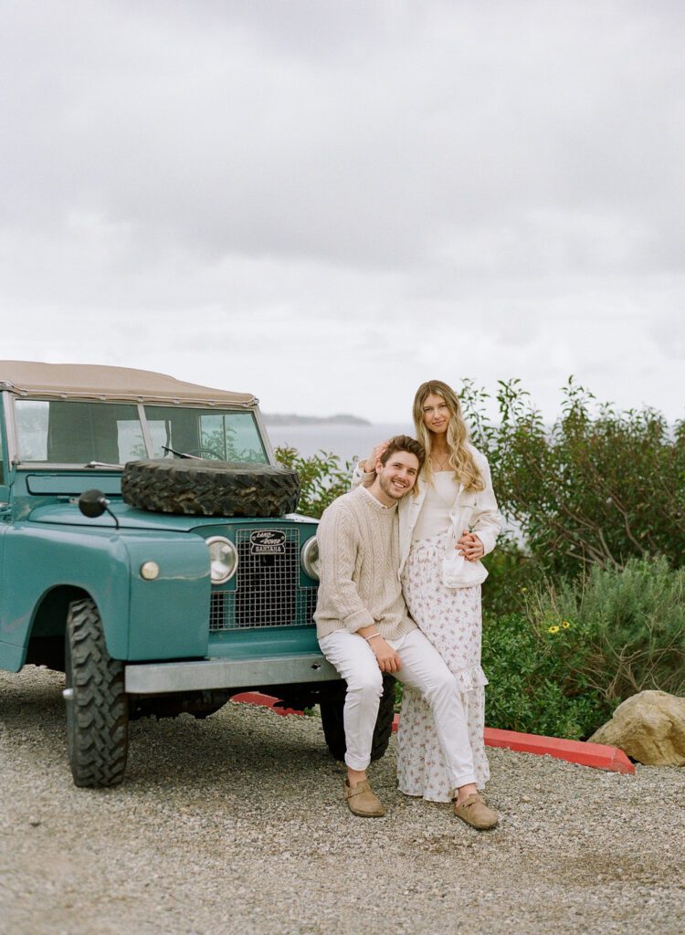 Couple Sitting on Land Rover