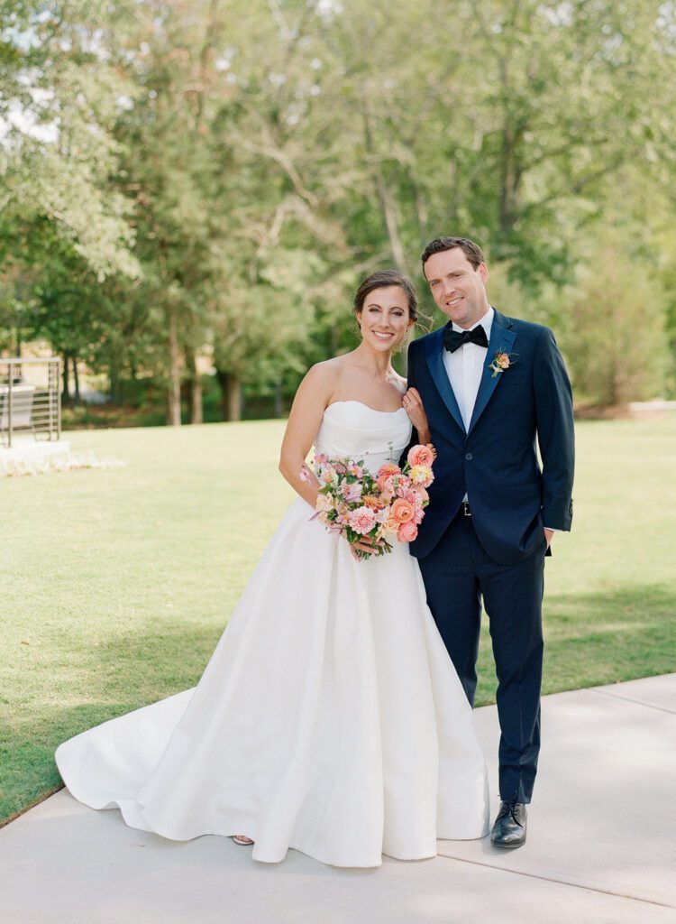 bride and groom smiling at camera 