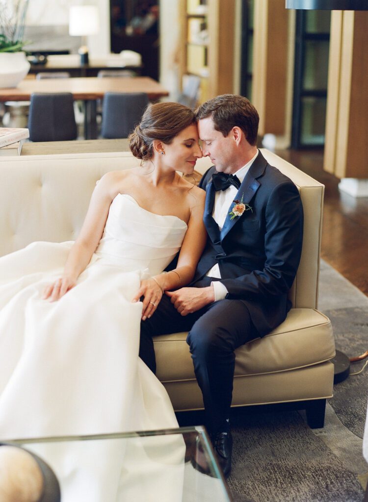 bride and groom sitting on couch 