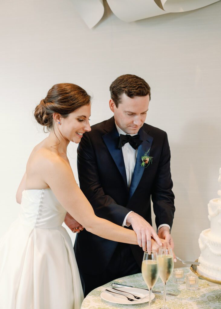 bride and groom cutting cake 