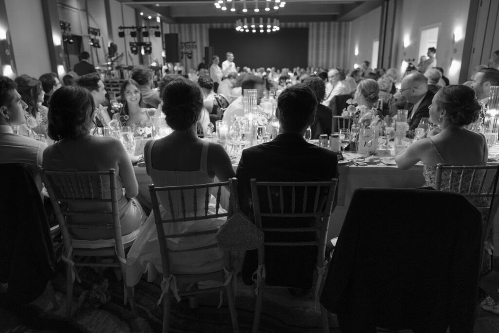 black and white of bride and groom at wedding reception 