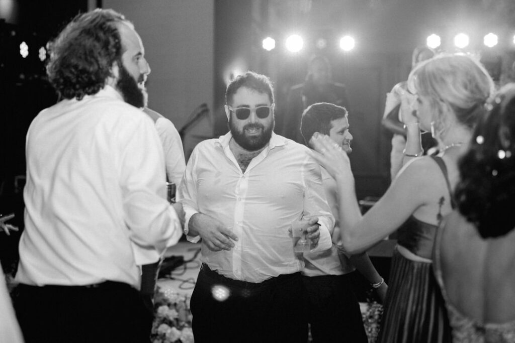 black and white of wedding guest dancing 