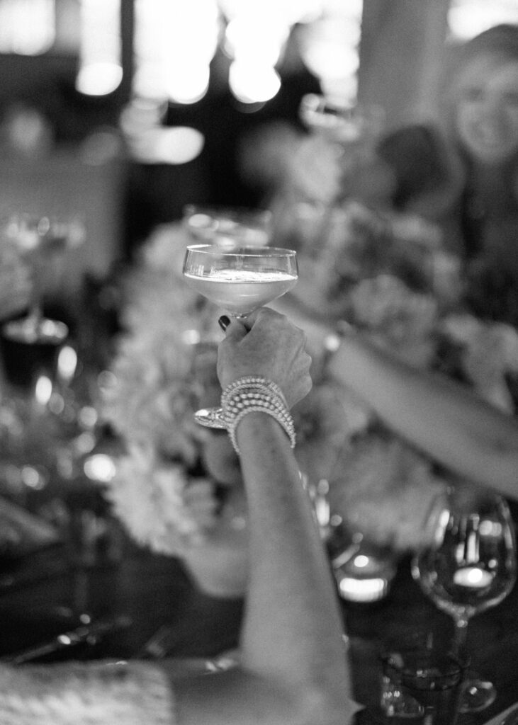 black and white of raised champagne glass