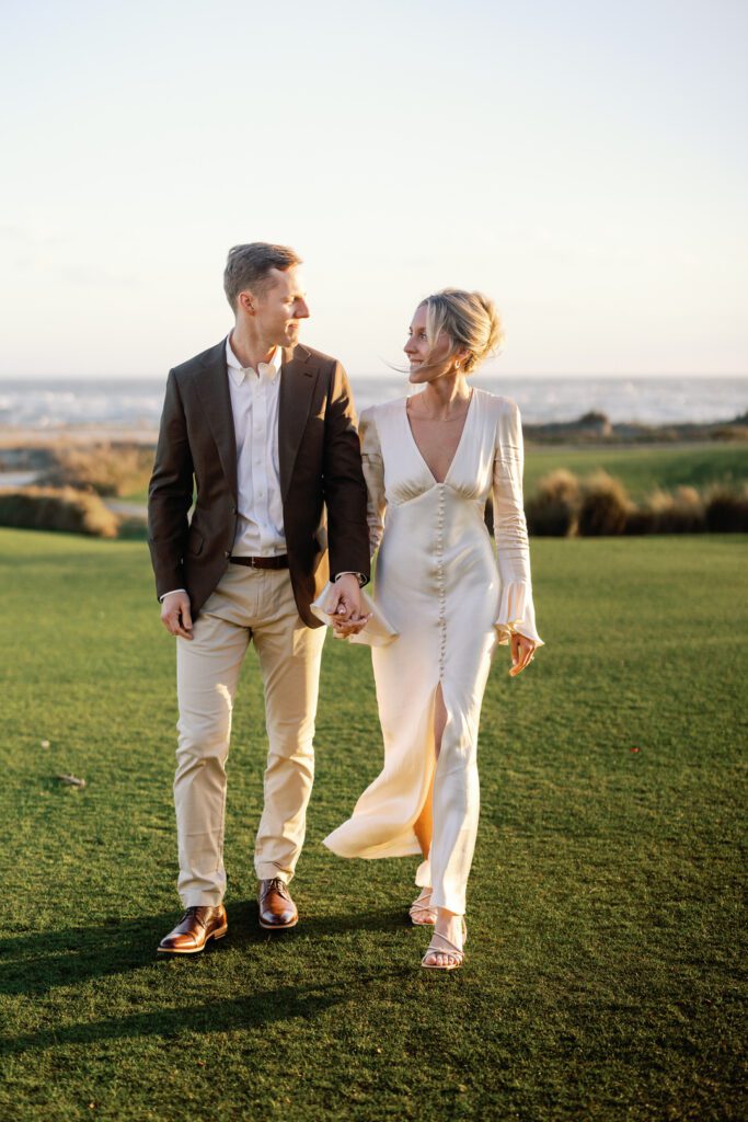 bride and groom holding hands walking