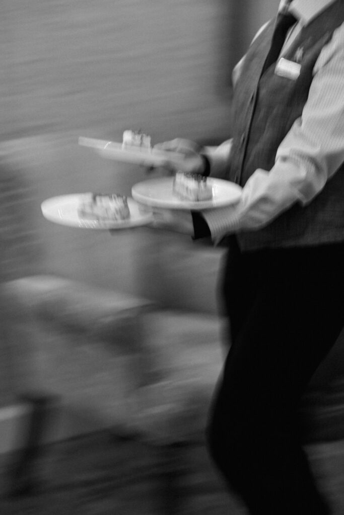 black and white of the waiter serving cake