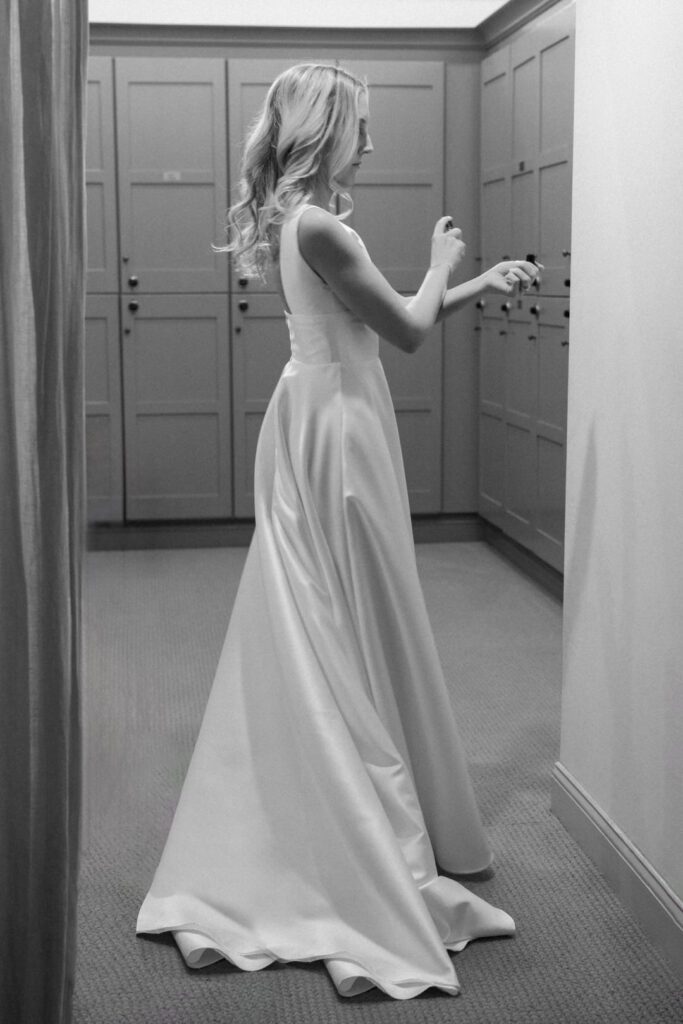 black and white of bride spraying perfume