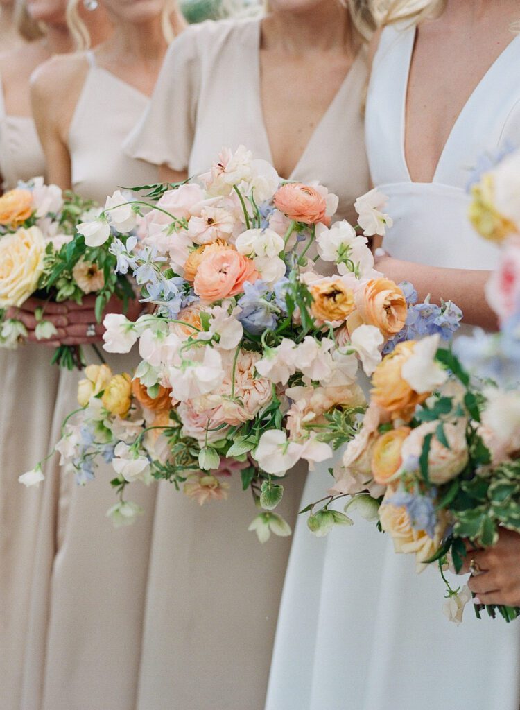 bride and bridesmaids holing bouquets