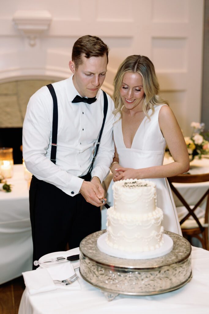 bride and groom cutting cake