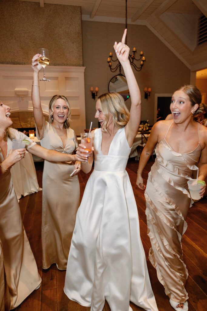 bride dancing with bridesmaids at Kiawah Island River Course wedding reception