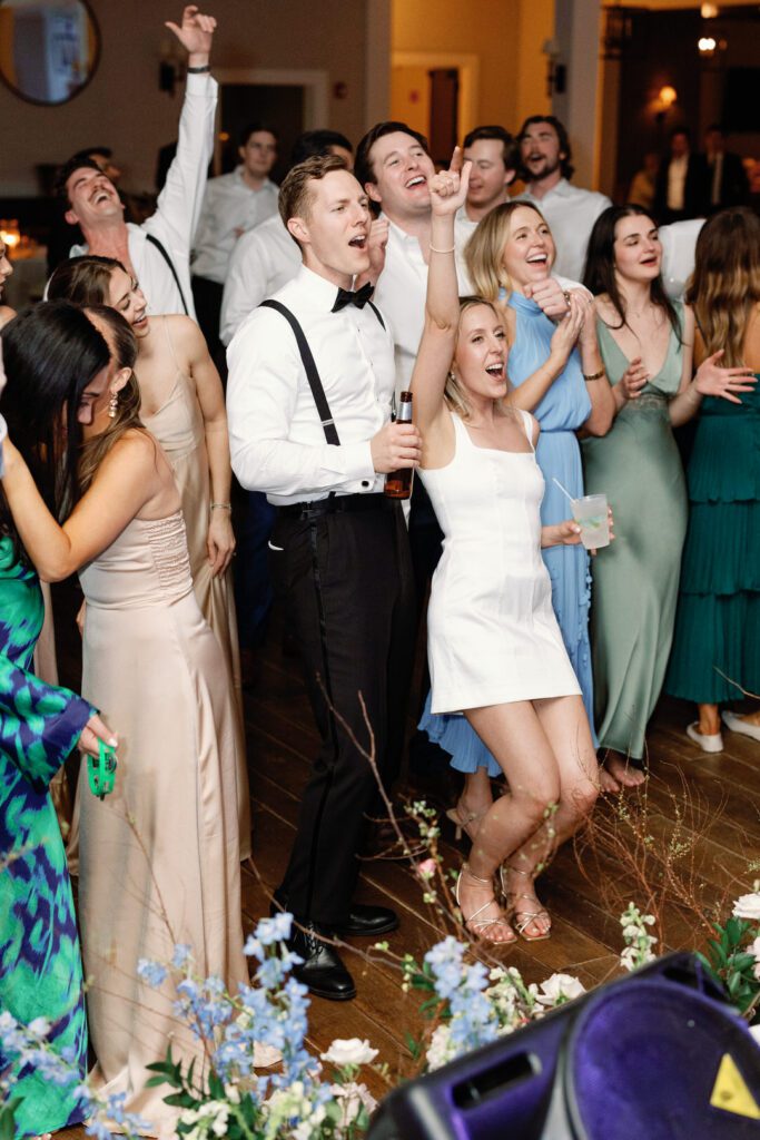 bride and groom singing and dancing at wedding reception