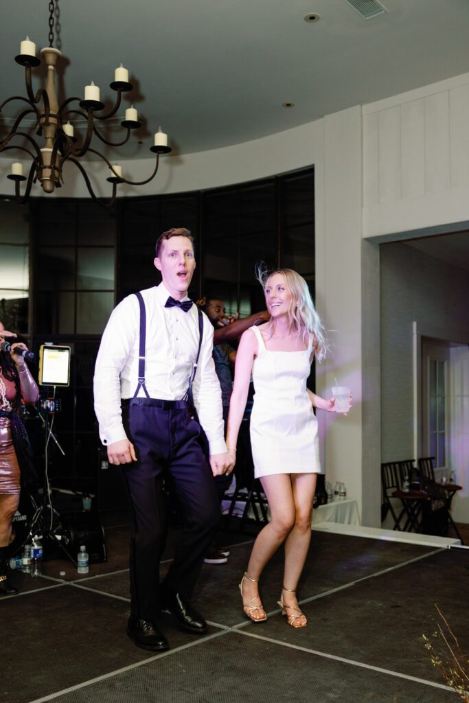 bride and groom on stage singing at Kiawah Island River Course wedding reception