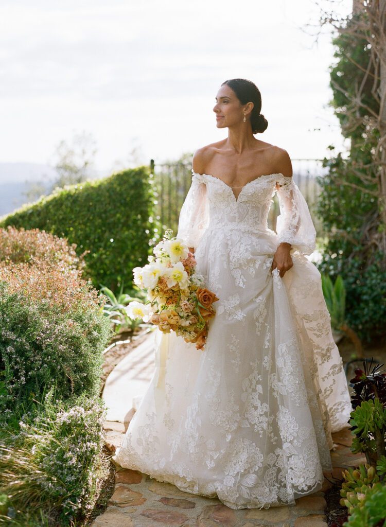 Bride Holding Dress Walking Path 