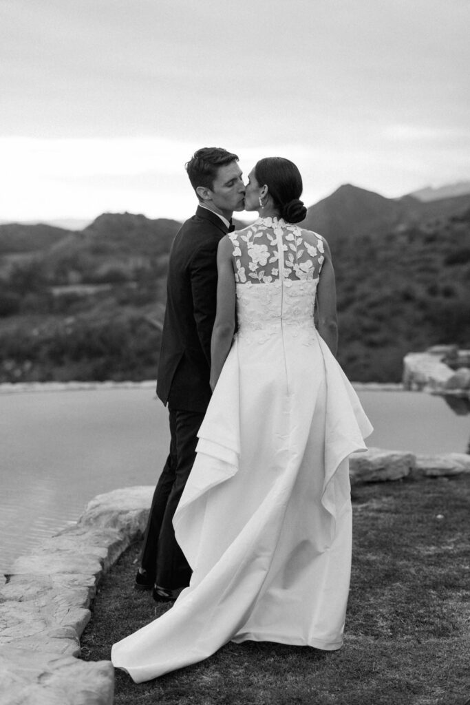 Black and white of bride and Groom kissing 