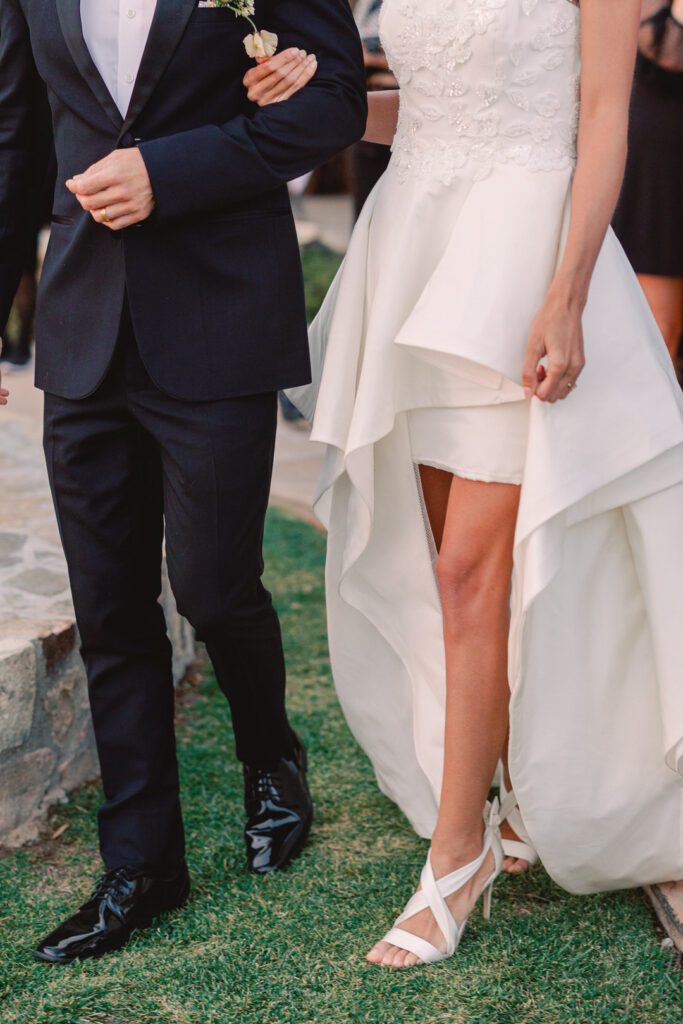 bride and groom holding hands walking 