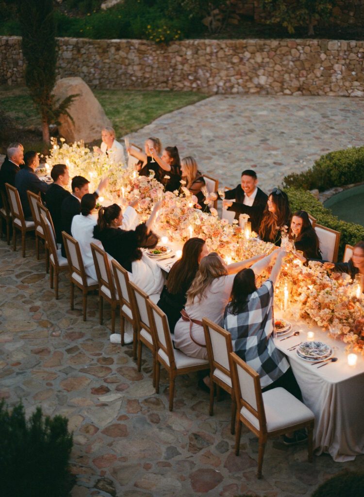 Candle Lit wedding reception guests toasting 