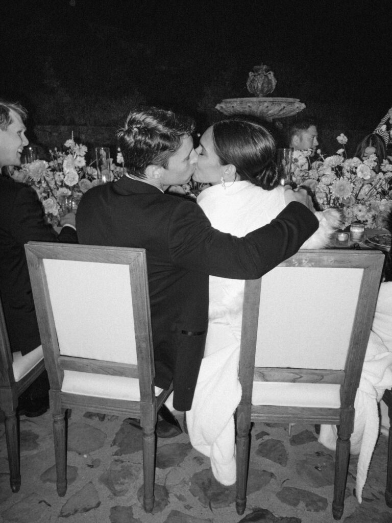 Black and White of bride and groom kissing 