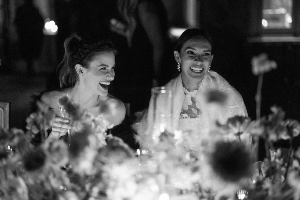 Black and white of Bride and Maid of Honor Laughing 