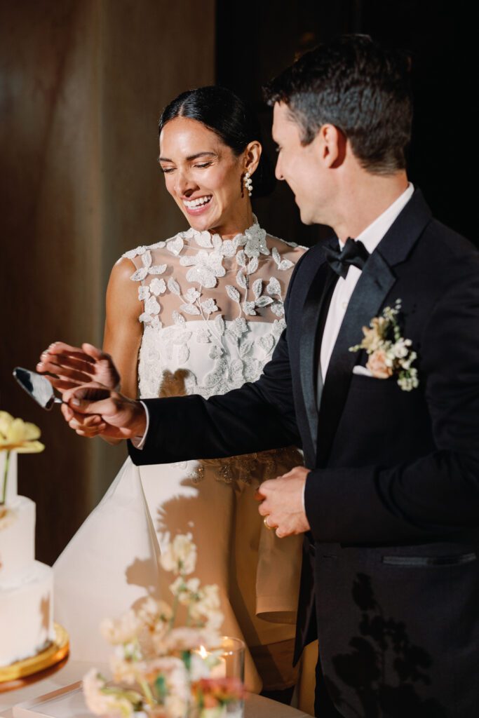 bride and groom cutting cake 