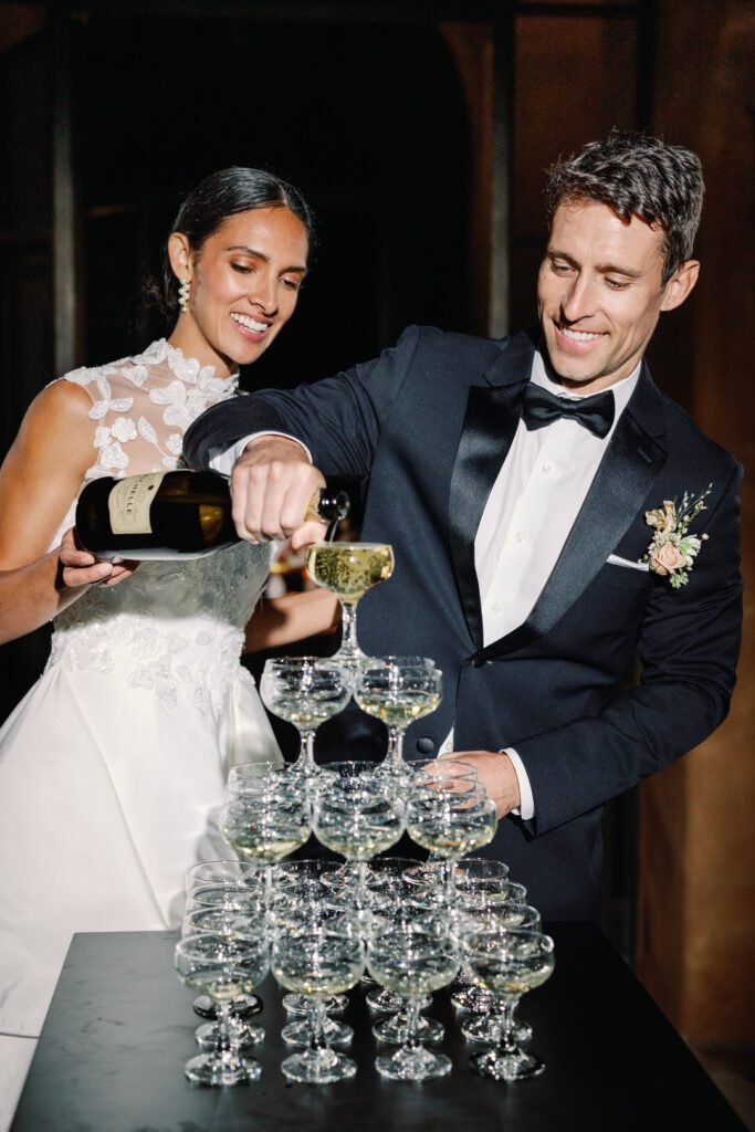 bride and groom pouring champagne tower 