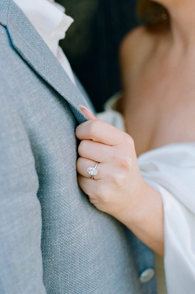 bride holding grooms jacket