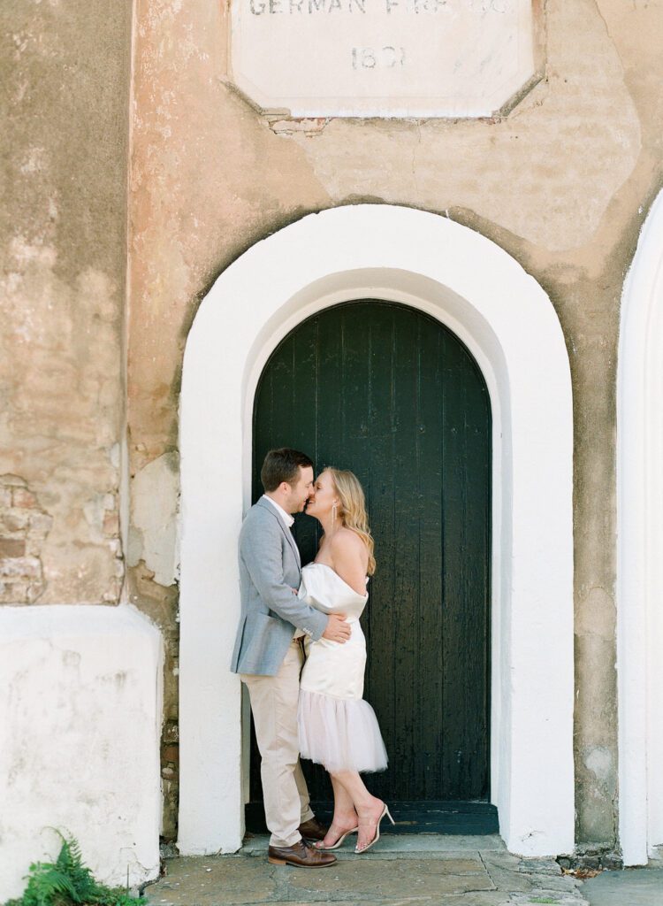 bride and groom kissing in doorway