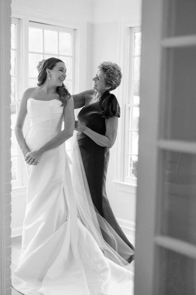 Black and white of bride and mother of bride getting ready