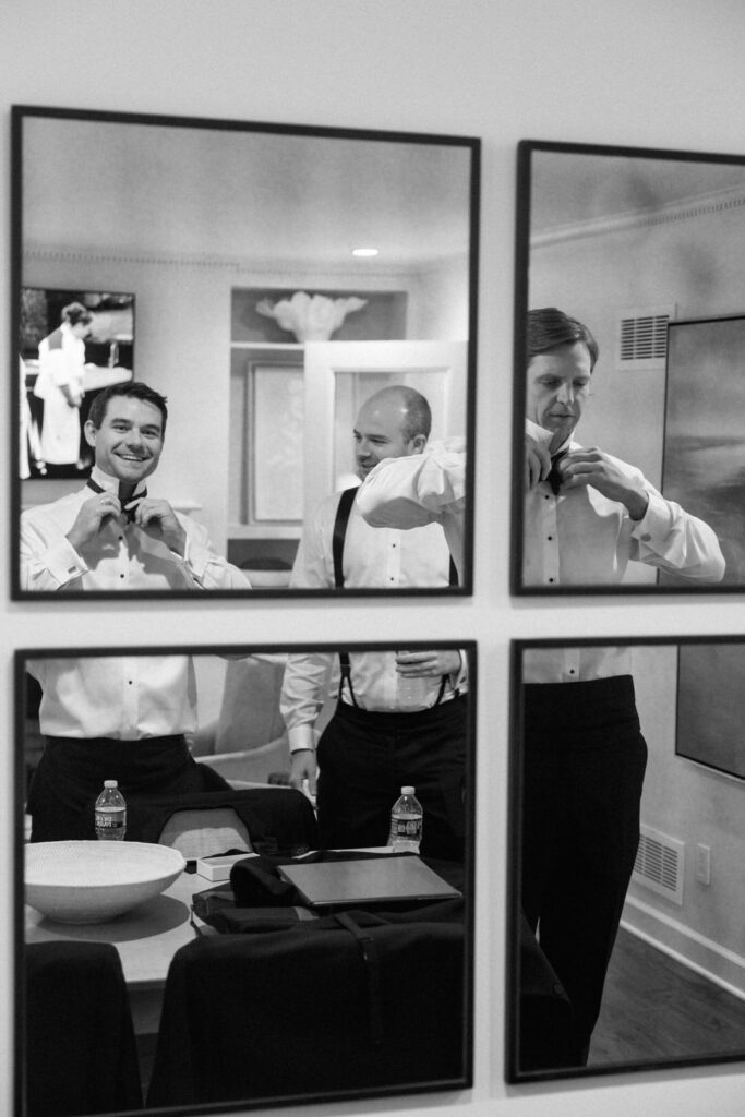 black and white of groomsmen getting ready