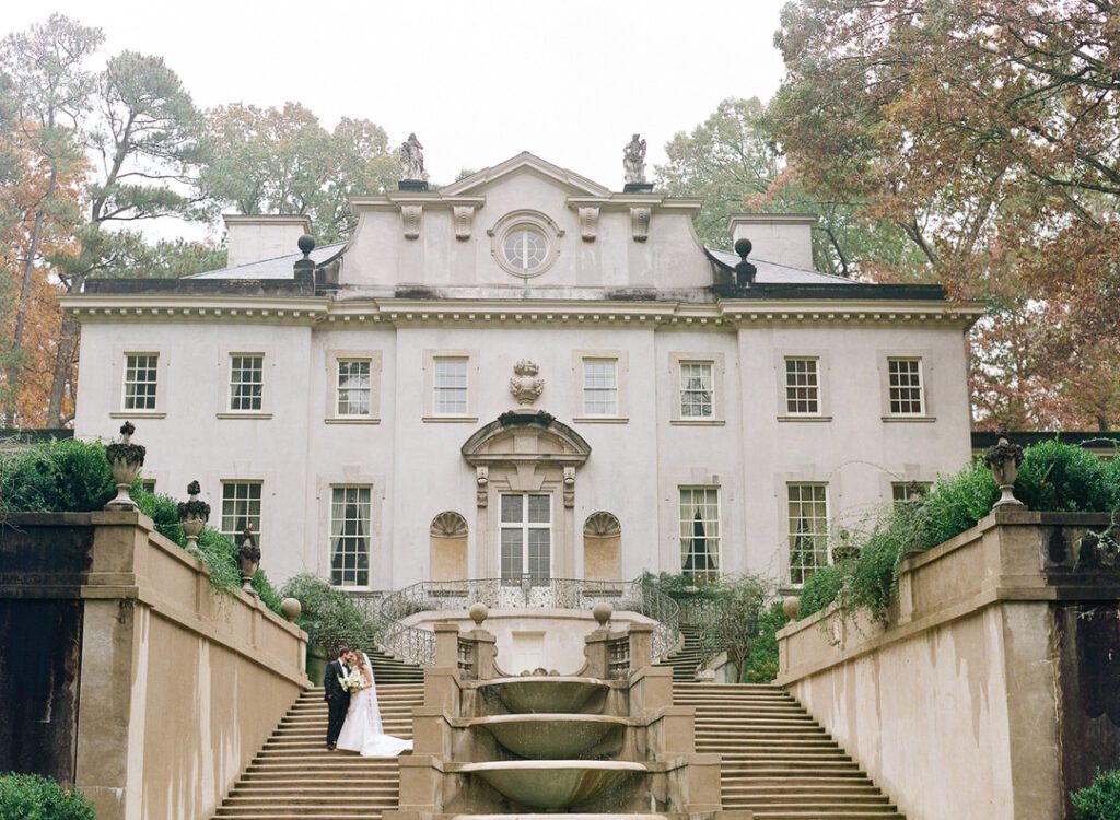 bride and groom on stairs at Swan House