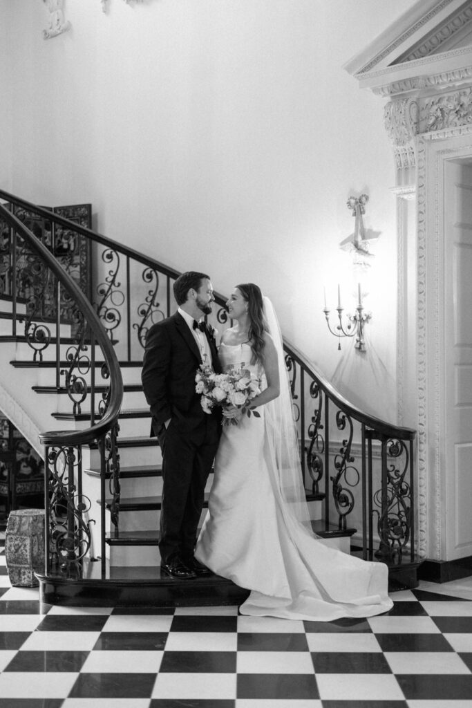 black and white of bride and groom on steps at The Swan House