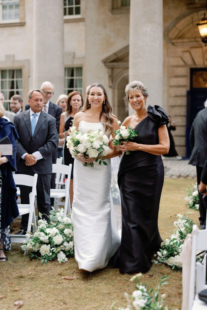 mother of bride walking bride down aisle