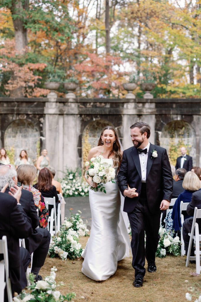 bride and groom smiling exiting ceremony