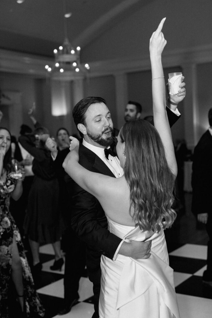 black and white of bride and groom dancing