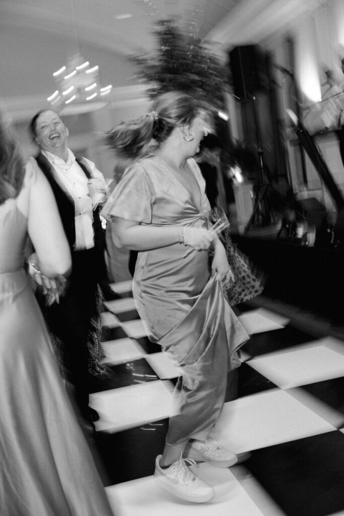 black and white of bridesmaid dancing