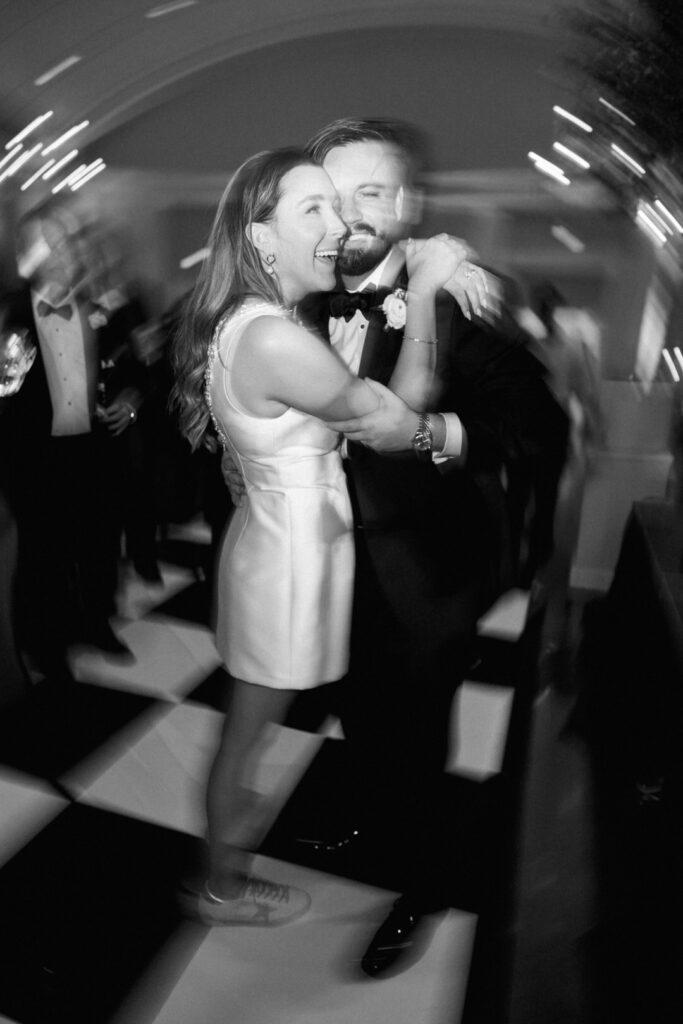 black and white of bride and groom dancing at reception