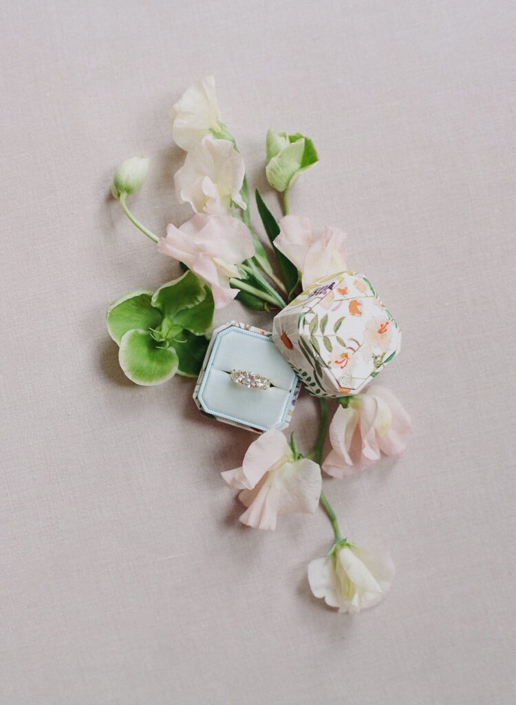 The bride's engagement ring in ring box with flowers