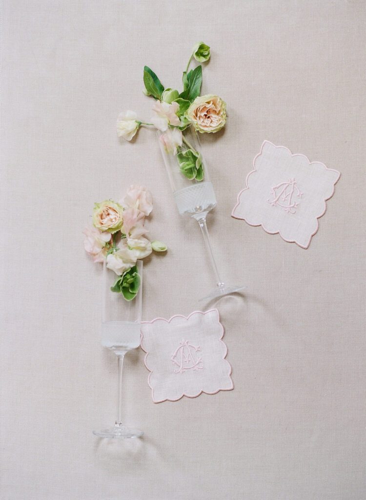 champagne flutes with custom coasters and flowers