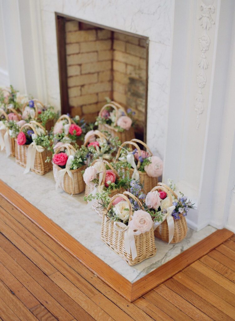 baskets of flowers in front of fire place