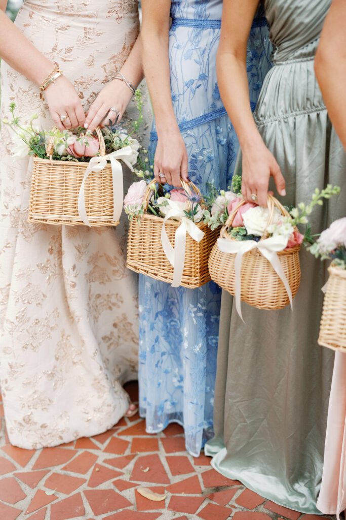 bridesmaids holding baskets of flowers