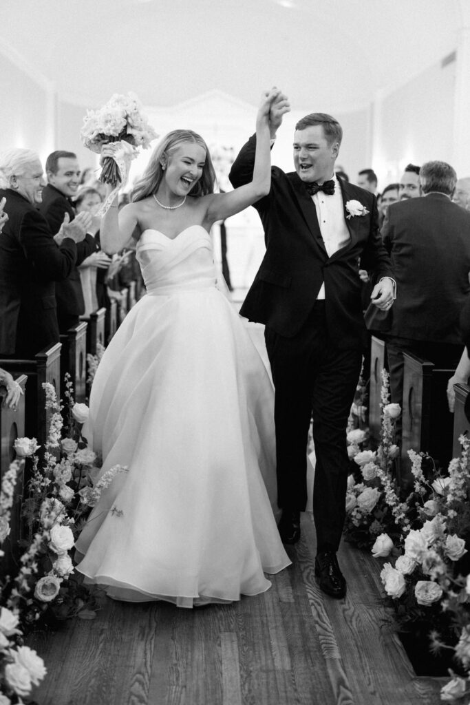 black and white of bride and groom exiting ceremony